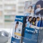 A set of colorful trifold brochures sit in a pharmacy showcasing the final stages of effective brochure creation