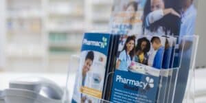 A set of colorful trifold brochures sit in a pharmacy showcasing the final stages of effective brochure creation